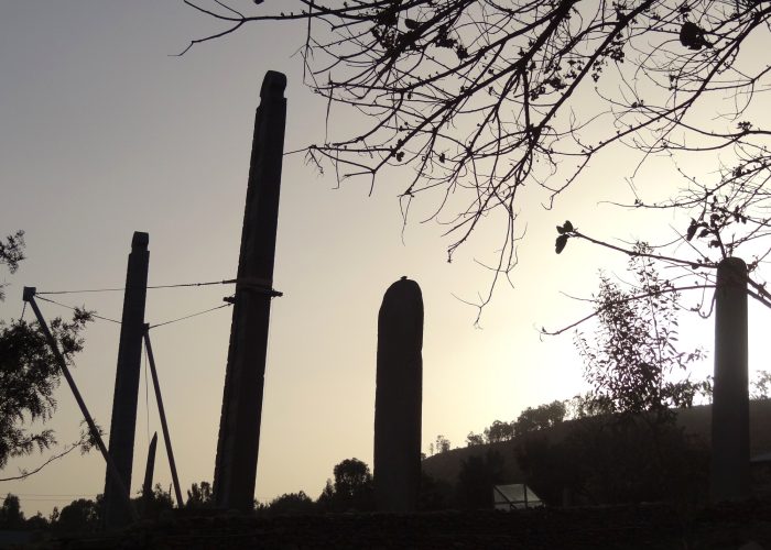 Ancient granite stelae of Aksum's Main Stelae Field silhouetted at sunset