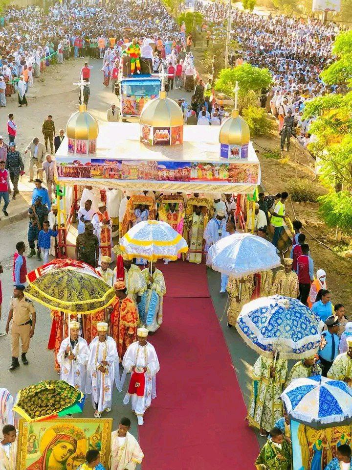 Clergy escort a tabot under ceremonial umbrellas during Timket